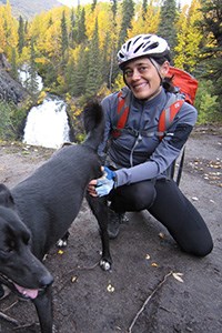 woman in running attire kneeling next to a dog woman in running attire kneeling next to a dog