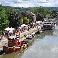 View of tugboats, barges, and boats tied up along the Erie Canal
