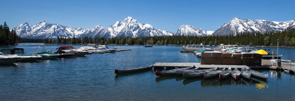 Boats and canoes at Colter Bay Marina on Jackson Lake, Grand Teton National Park