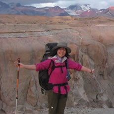 A Japanese international volunteer with a backpack explores the wilderness of Katmai National Park.