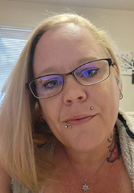 Stephanie Auten A person wearing glasses looks into the camera.