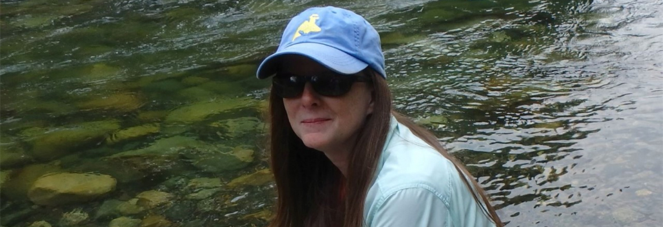 Susan McClendon Susan McClendon sitting near a waterway.