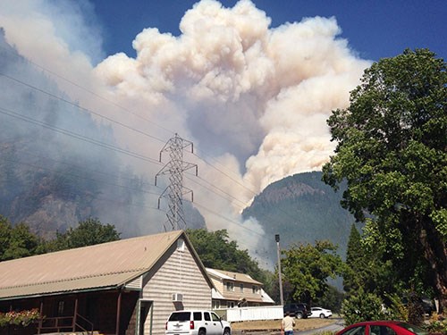 residential area with wildfire smoke in the distance