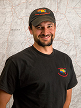 jay-lusher-usfs-photo-kari-greer-sm Jay Lusher stands in front of a map.