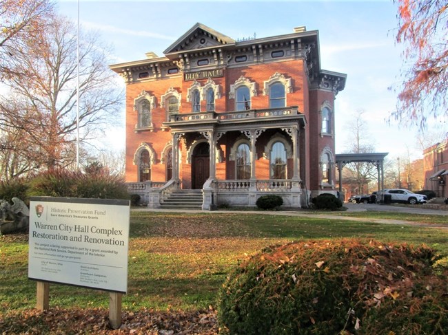 A decorative red brick center hall colonial home now a city hall.