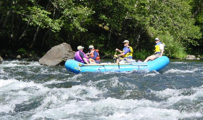 Several people on a raft in whitewater