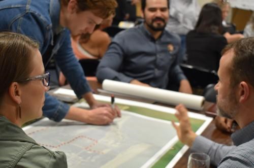 A group gathers around a map