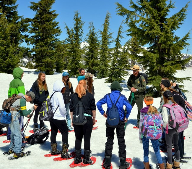lt= A group of students listen to a park ranger