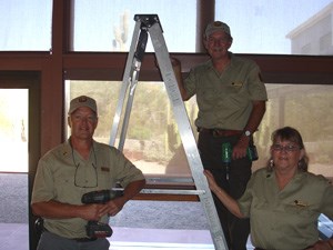 Volunteers pose after hanging new blinds in the visitor center Volunteers pose after hanging new blinds in the visitor center