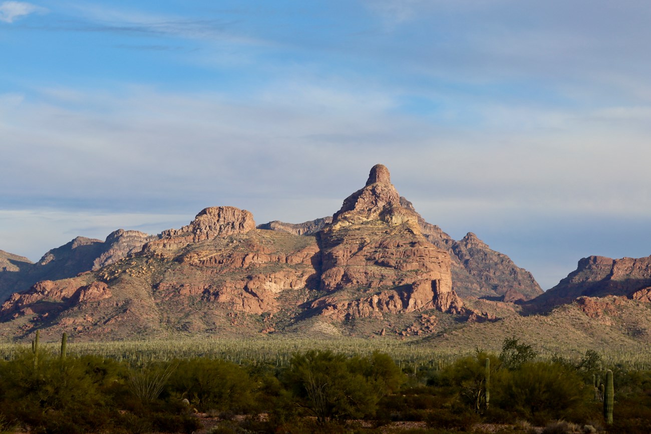 A mountain with unique layered structure in morning sunlight.