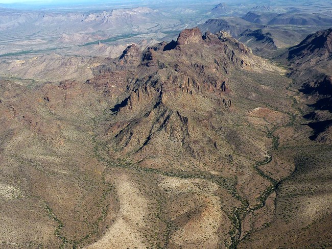 Alluvial fans in the form of bajadas sloping away from a mountain.