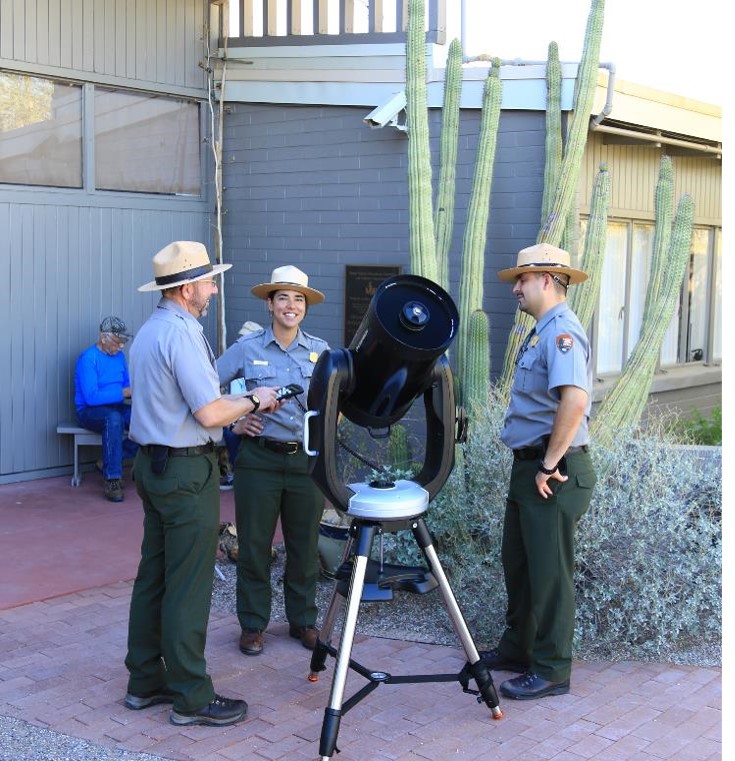 3 rangers working with the new night sky telescope