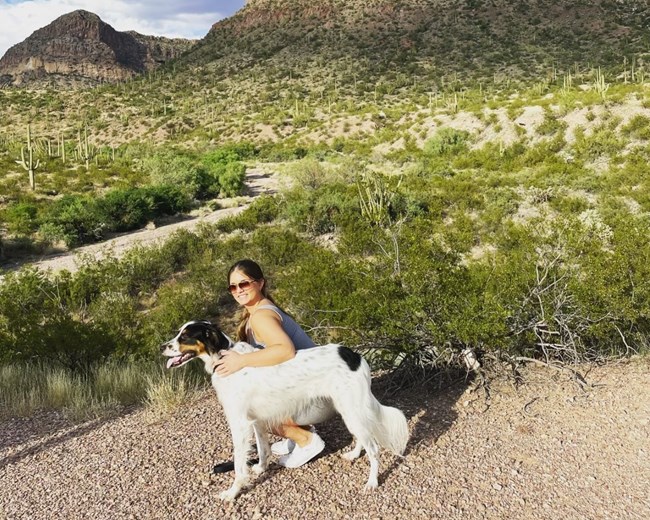 A woman cuddles her dog