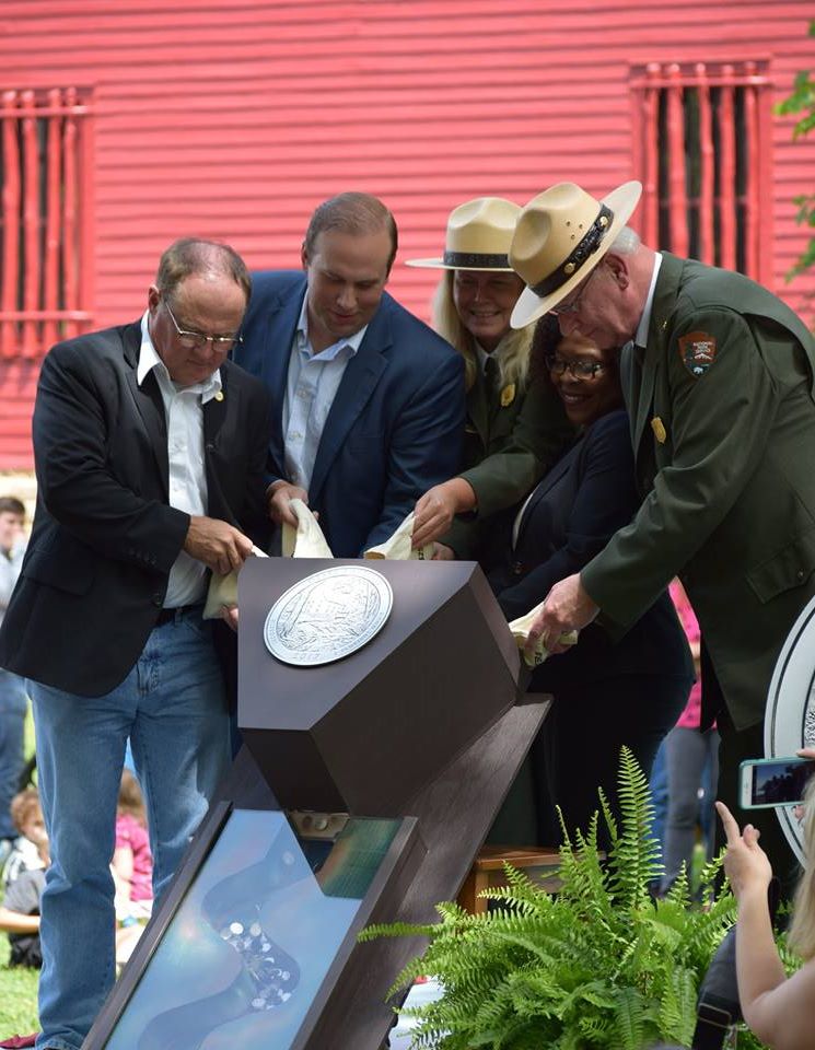 dignitaries participate in the ceremonial coin pour releasing the ONSR quarter