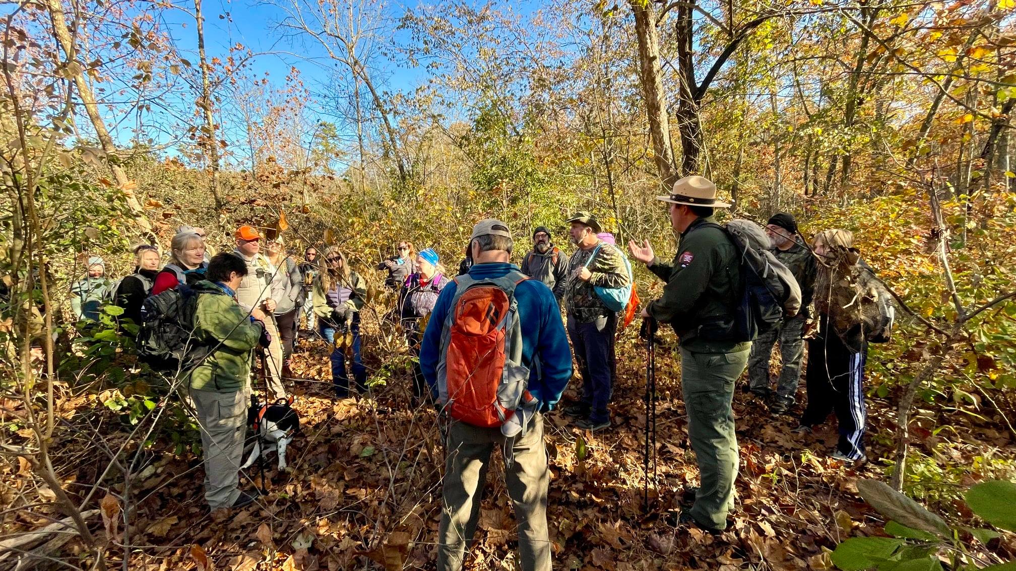 270424553_2838015ss53776958_4708540318838378620_n A group of hikers with a park ranger in the fall woods