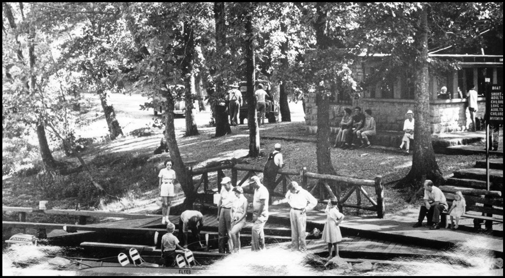 john boats at lodge lined up, black and white photo