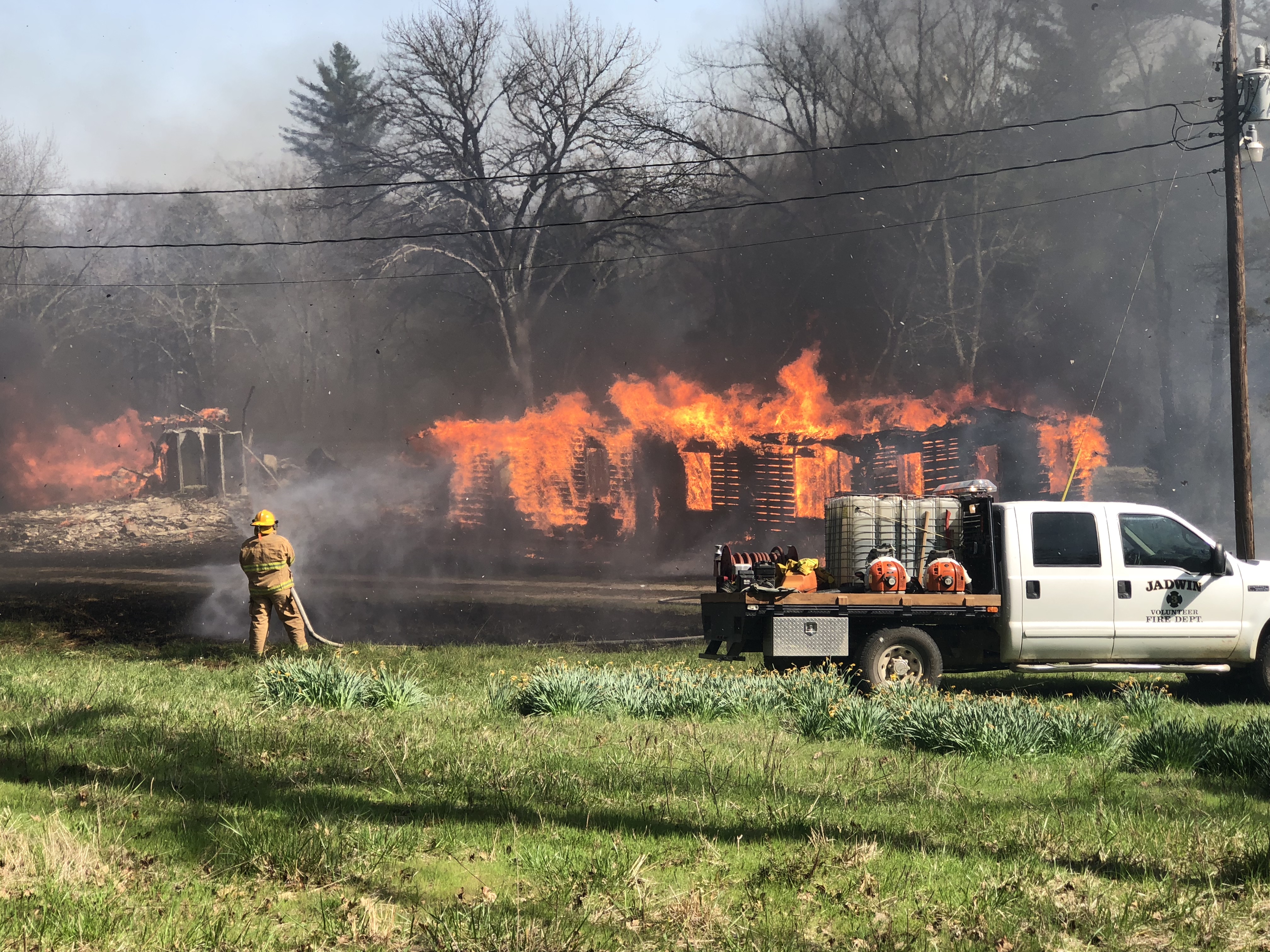 firefighters battle a blazing building with water hoses