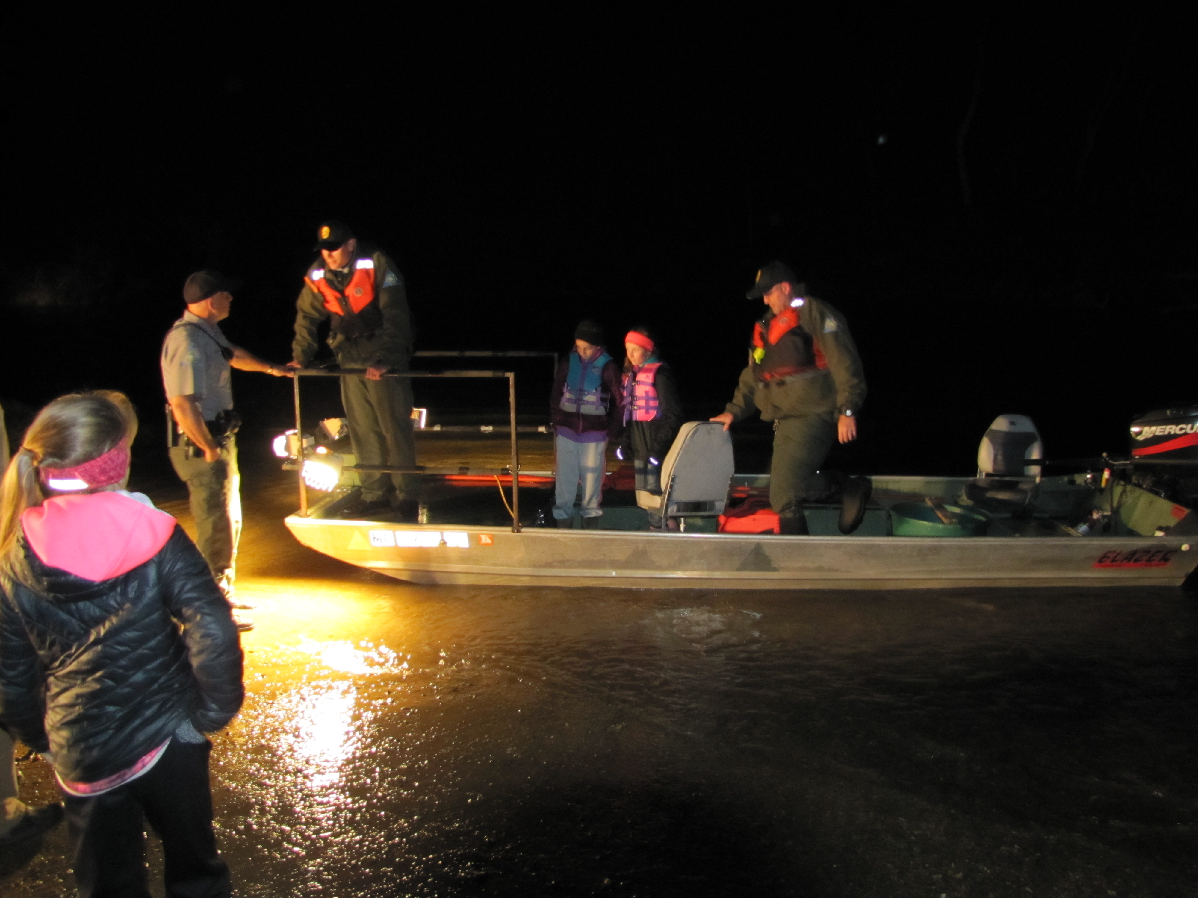 Youth in john boat with MDC Agents