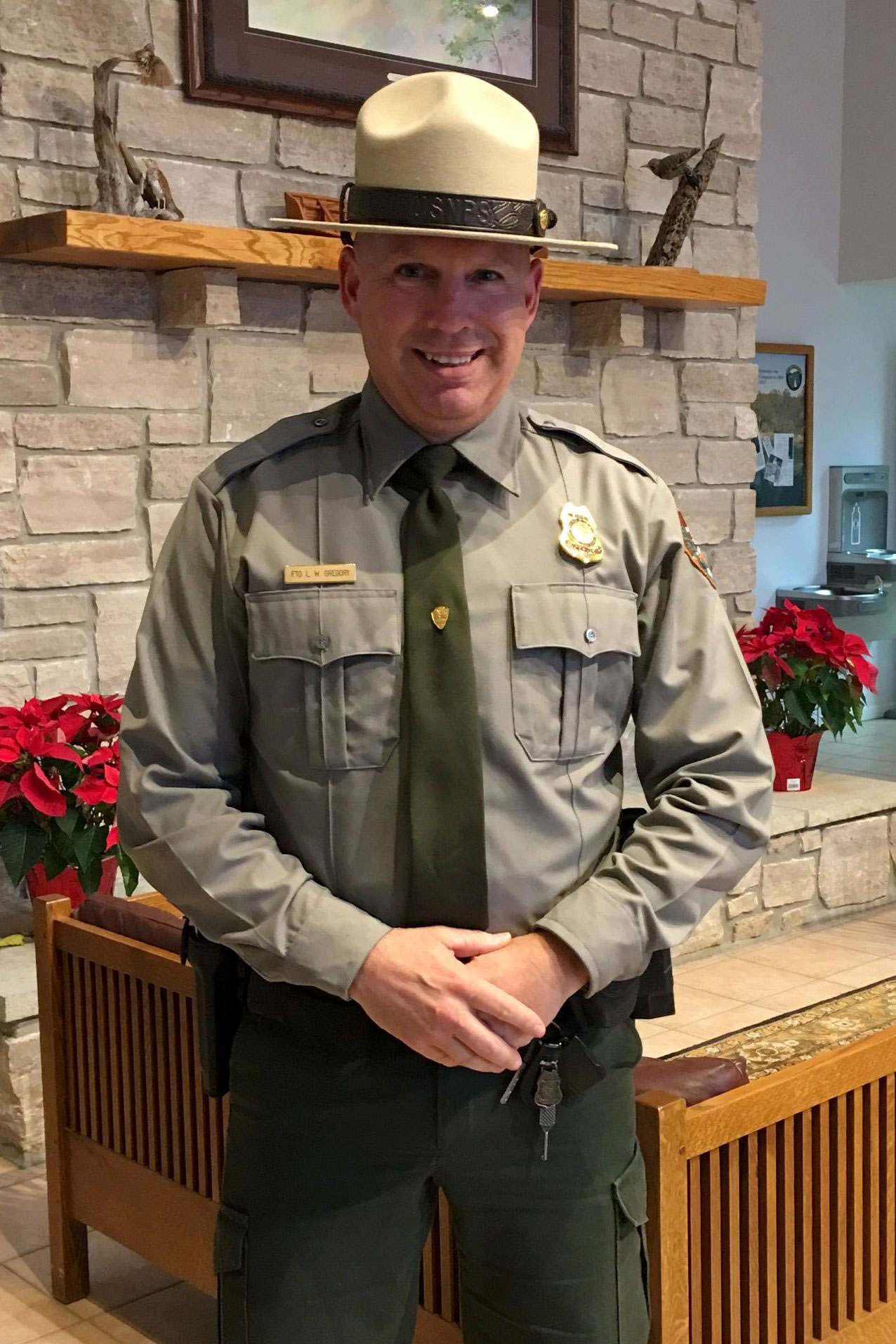 Chief Ranger Lindel Gregory stands in front of the mantle at Park Headquarters