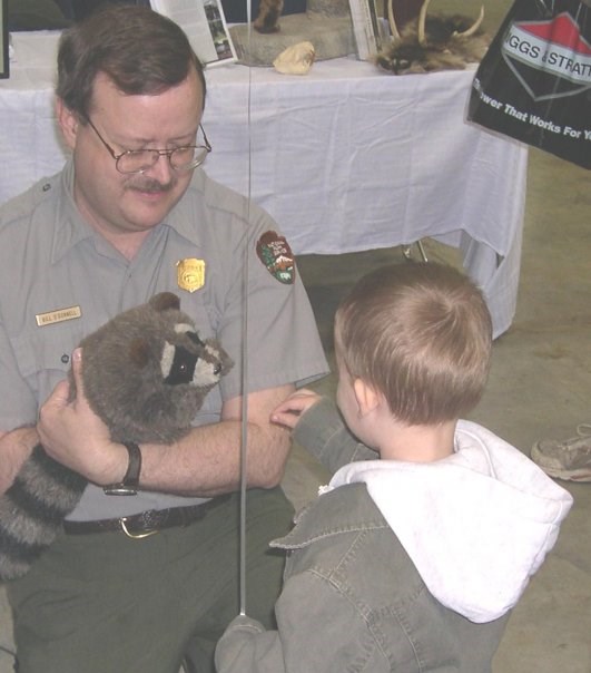 Ranger Bill with child and raccoon puppet