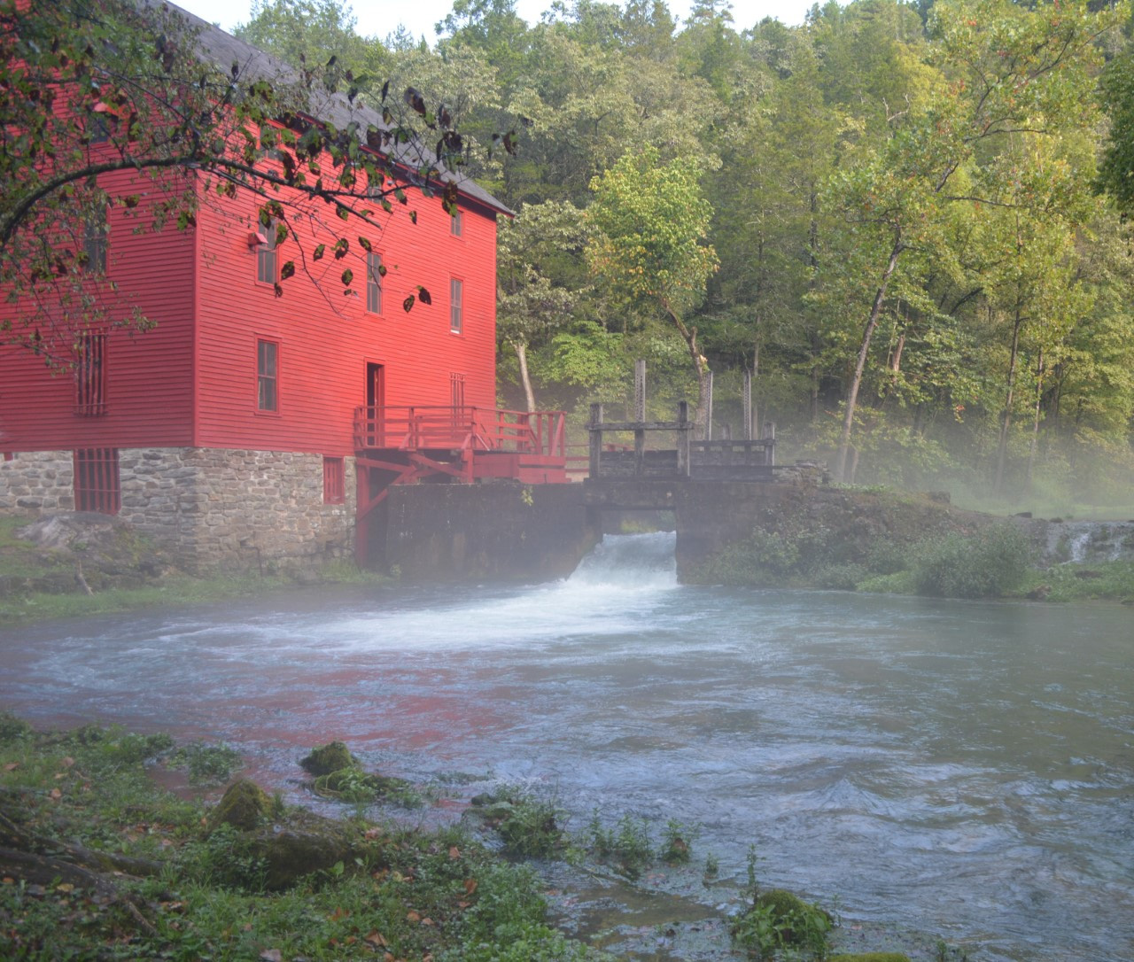 downloadsfasfsd Red alley mill on banks of flowing spring with fog lifting