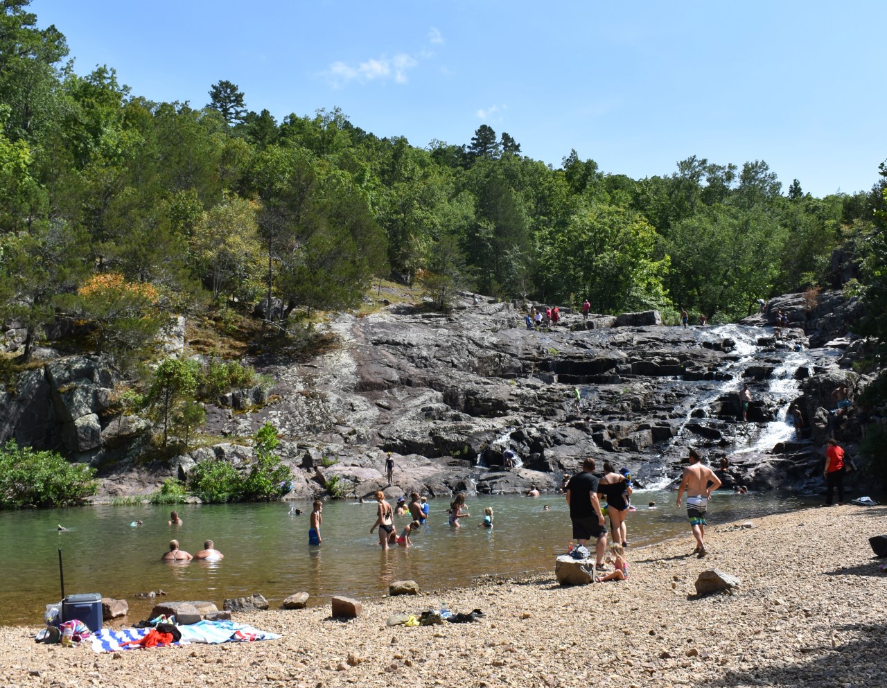 thumbnail_DSC_0182 A group of swimmers in a natural pool area at the base of a waterfall