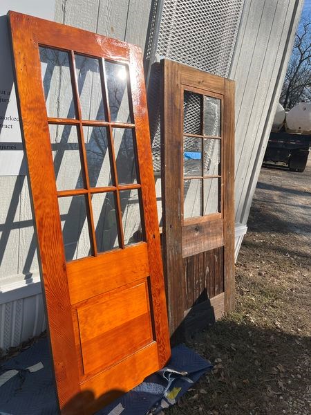 Two wooden doors side by side showing a renovated door versus an old door with its wood finish