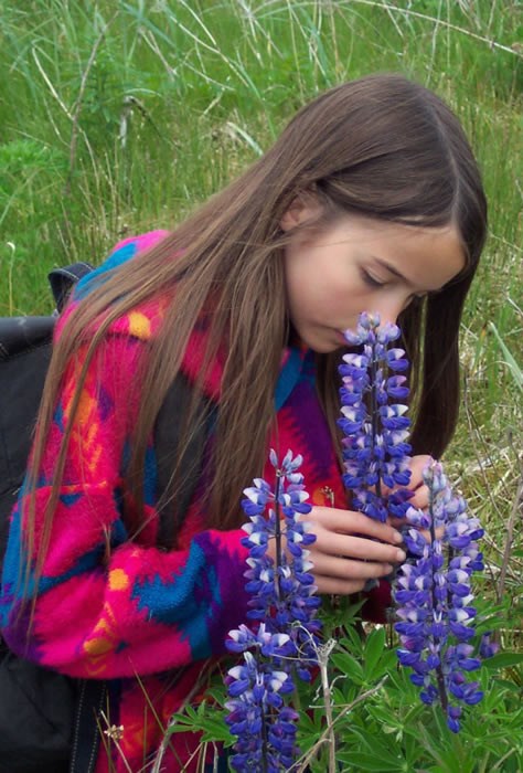 Girl smelling flowers