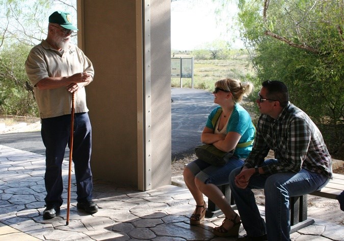 A volunteer talks to a couple of visitors A volunteer talks to a couple of visitors