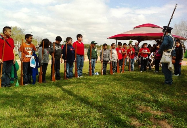 A living historian gives a program to a group of children