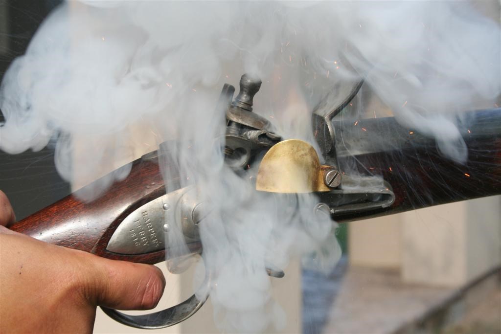 Smoke rising from the lock on a flintlock musket.