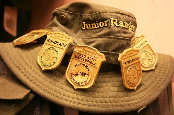 Junior Ranger bucket hat with Junior Ranger badges on it.