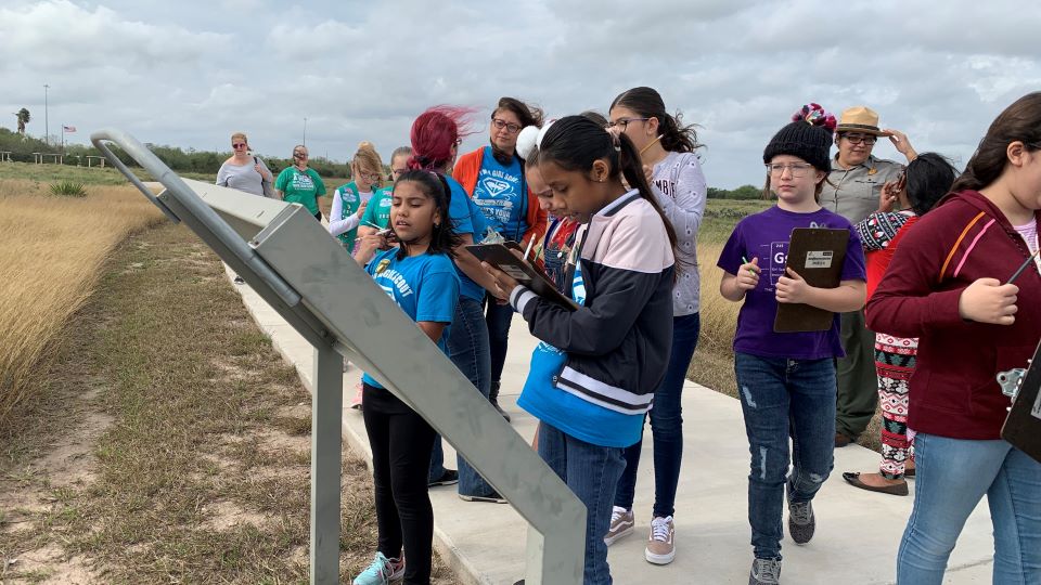 Girl Scouts on battlefield trail Girl Scouts reading a wayside and doing a written activity