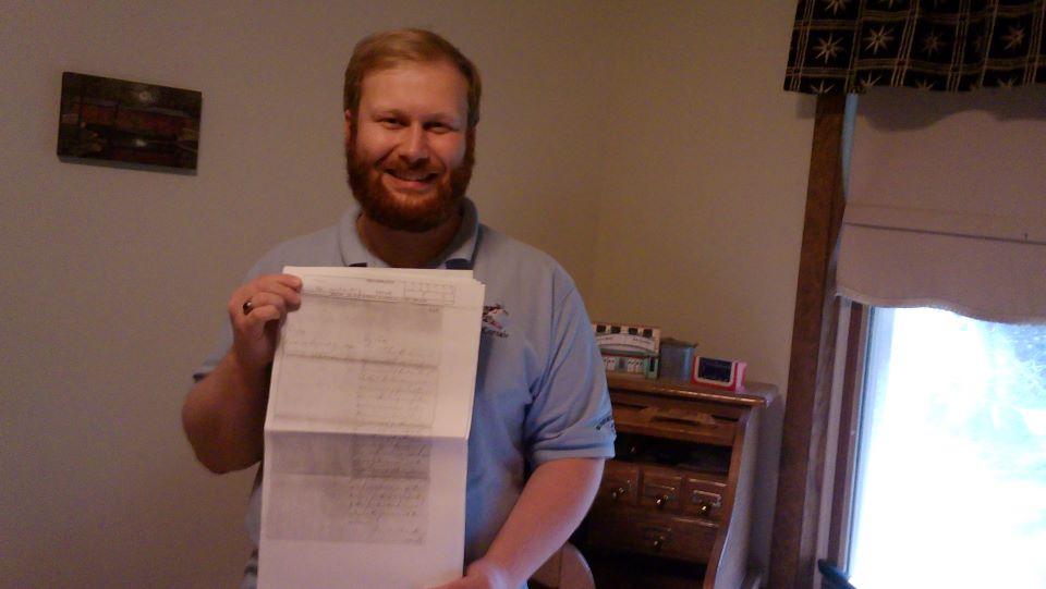 Park volunteer Eric Hipkins holding up a historical transcript.