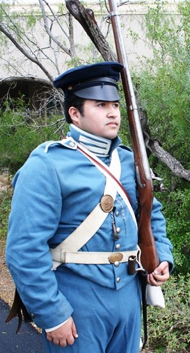 Living historian standing with a musket at shoulder arms