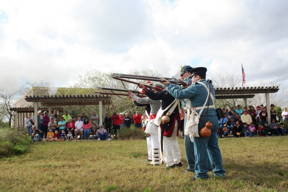 Group of living historian performs a musket demonstration.