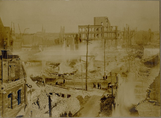 Burnt down buildings and debris lay in the city's streets.