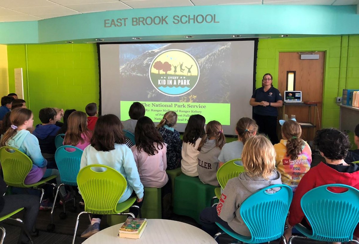 Community Volunteer Ambassador Kelsey is presenting an Every Kid in a Park Program to a class of fourth graders at East Brook School. Education Program