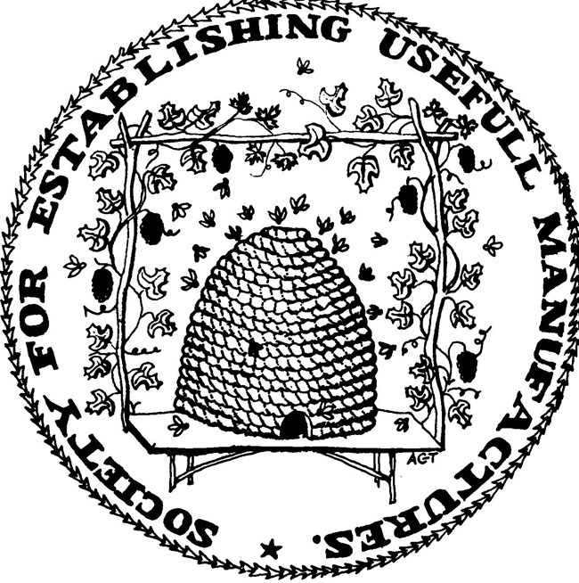 Logo for the Society for Establishing Useful Manufactures - a round wreath and text encircle a busy straw beehive framed by a grape trellis