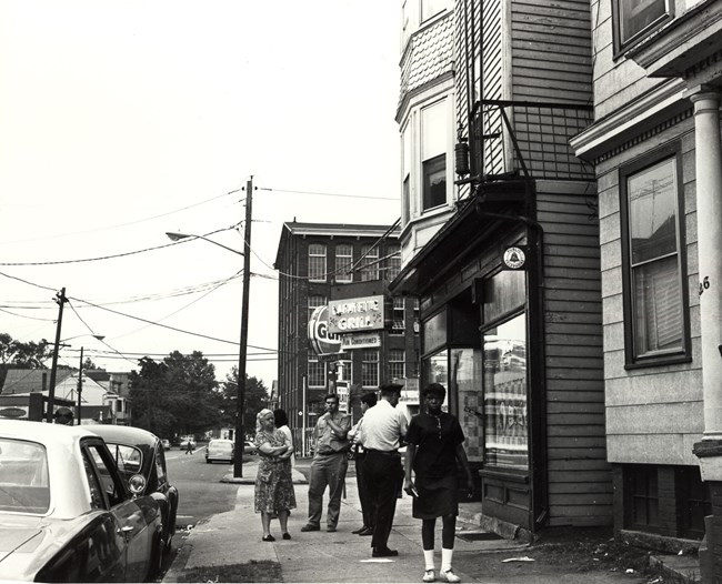 People & police stand outside the Lafayette Bar & Grille on 6/17/66, the morning after 3 people were shot inside