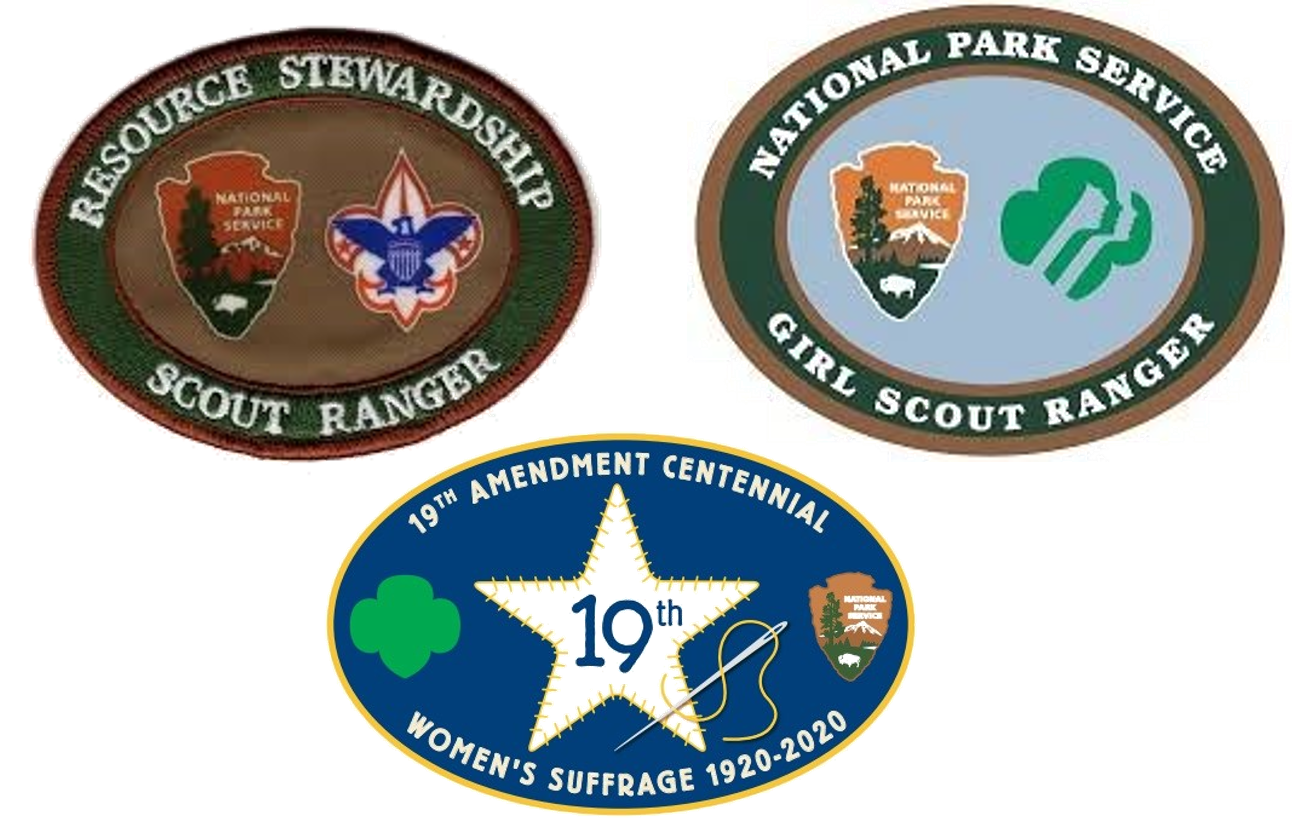 Group of Scout Patches - a brown resource stewardship badge with the NPS arrowhead & boy scout eagle, a light blue badge with the NPS arrowhead "pair of faces" girl scout logo, & a blue 19th Amendment patch with a five-point star, needle, & thread
