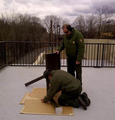 Two rangers assembling wayside exhibit