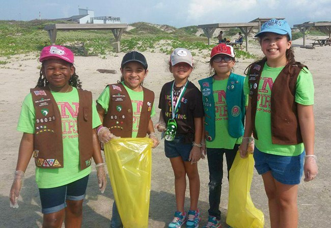 Girl Scouts participate in a beach clean-up at Malaquite Beach.