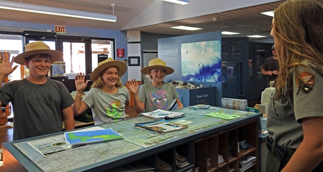 Park Ranger swearing in three new Junior Rangers