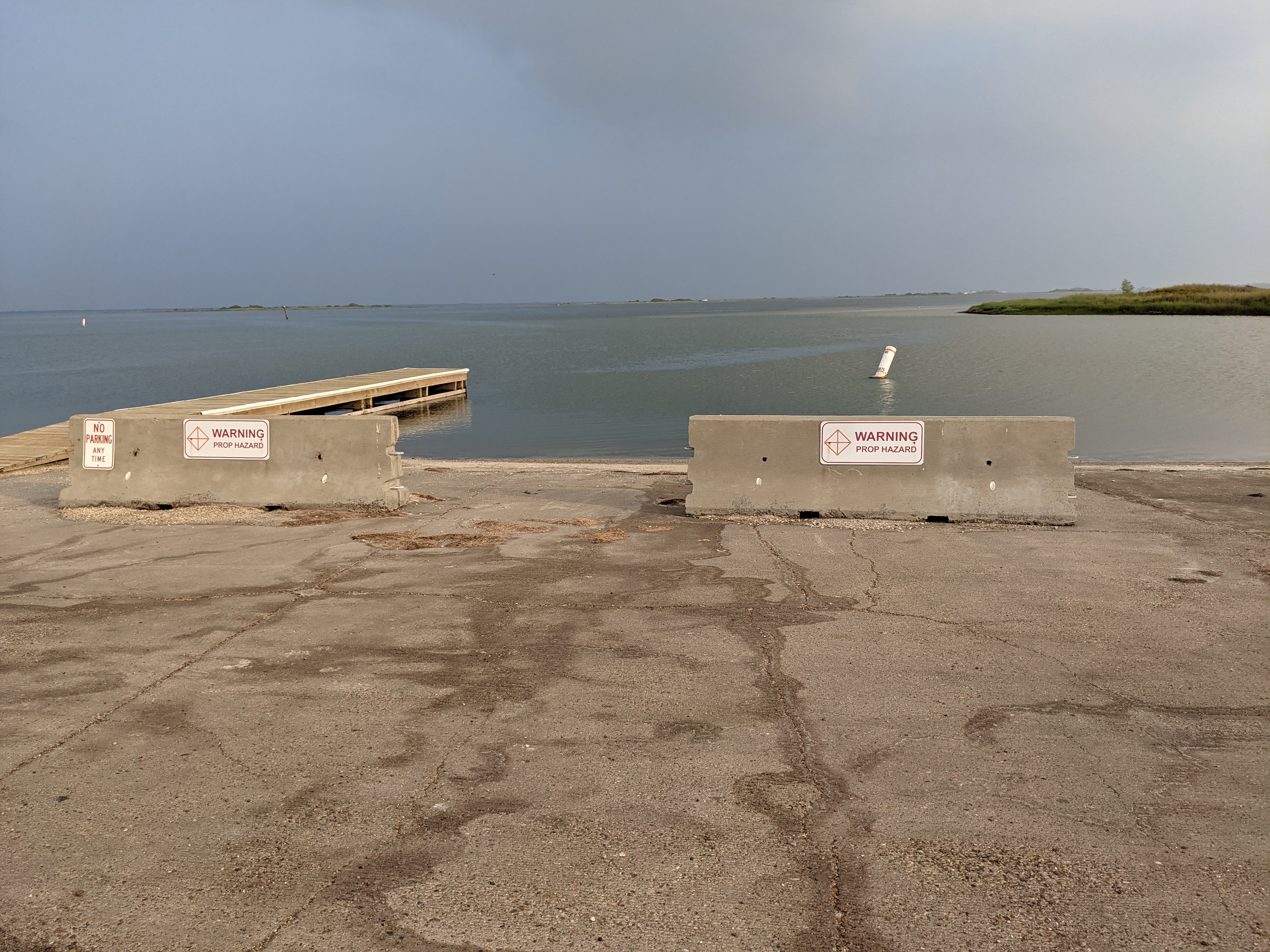 Concrete barricades block the entrance to the Bird Island Basin Boat Ramp