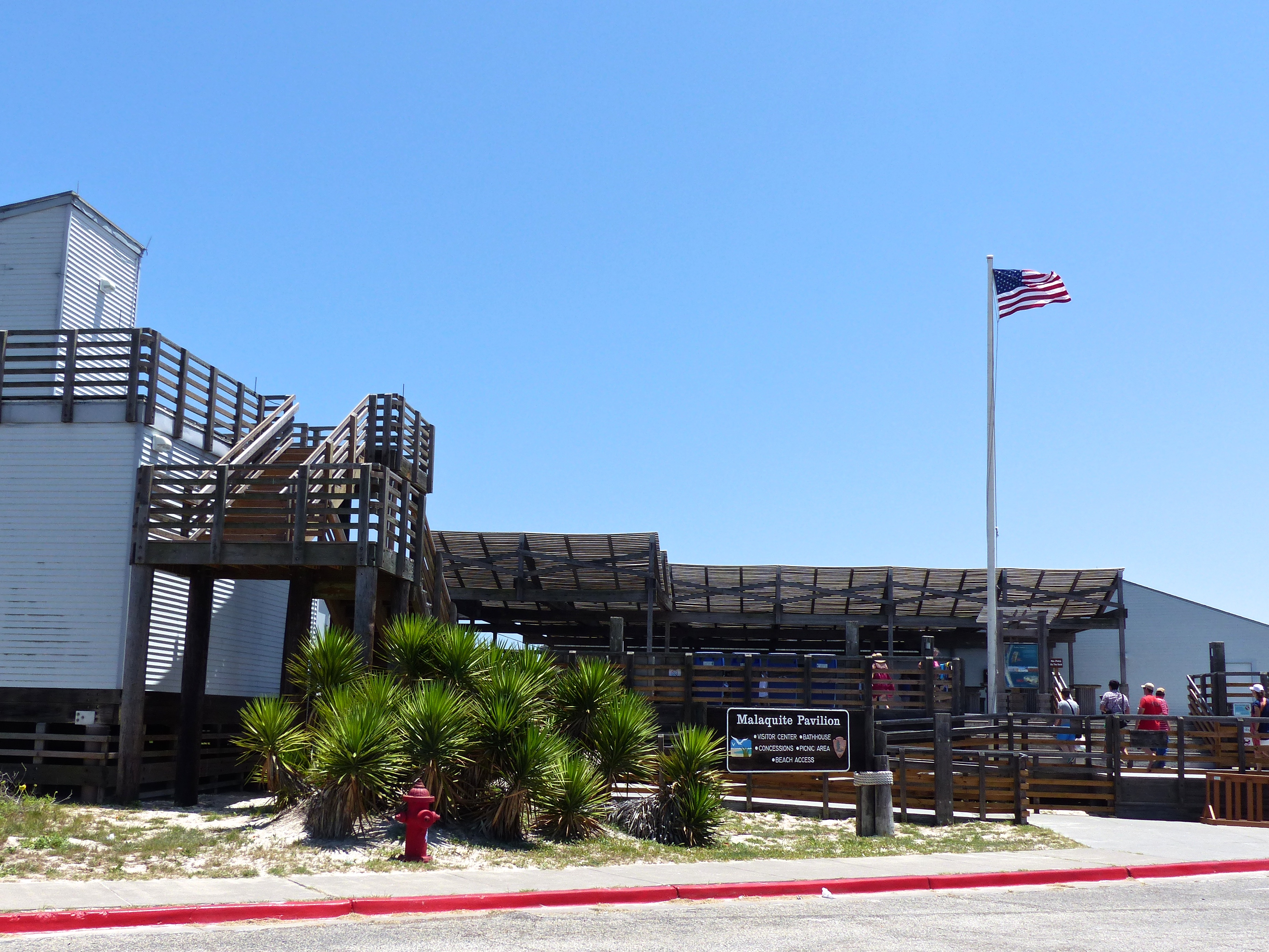 Malaquite Visitor Center The park visitor center with the US flag flying and visitors walking up the steps