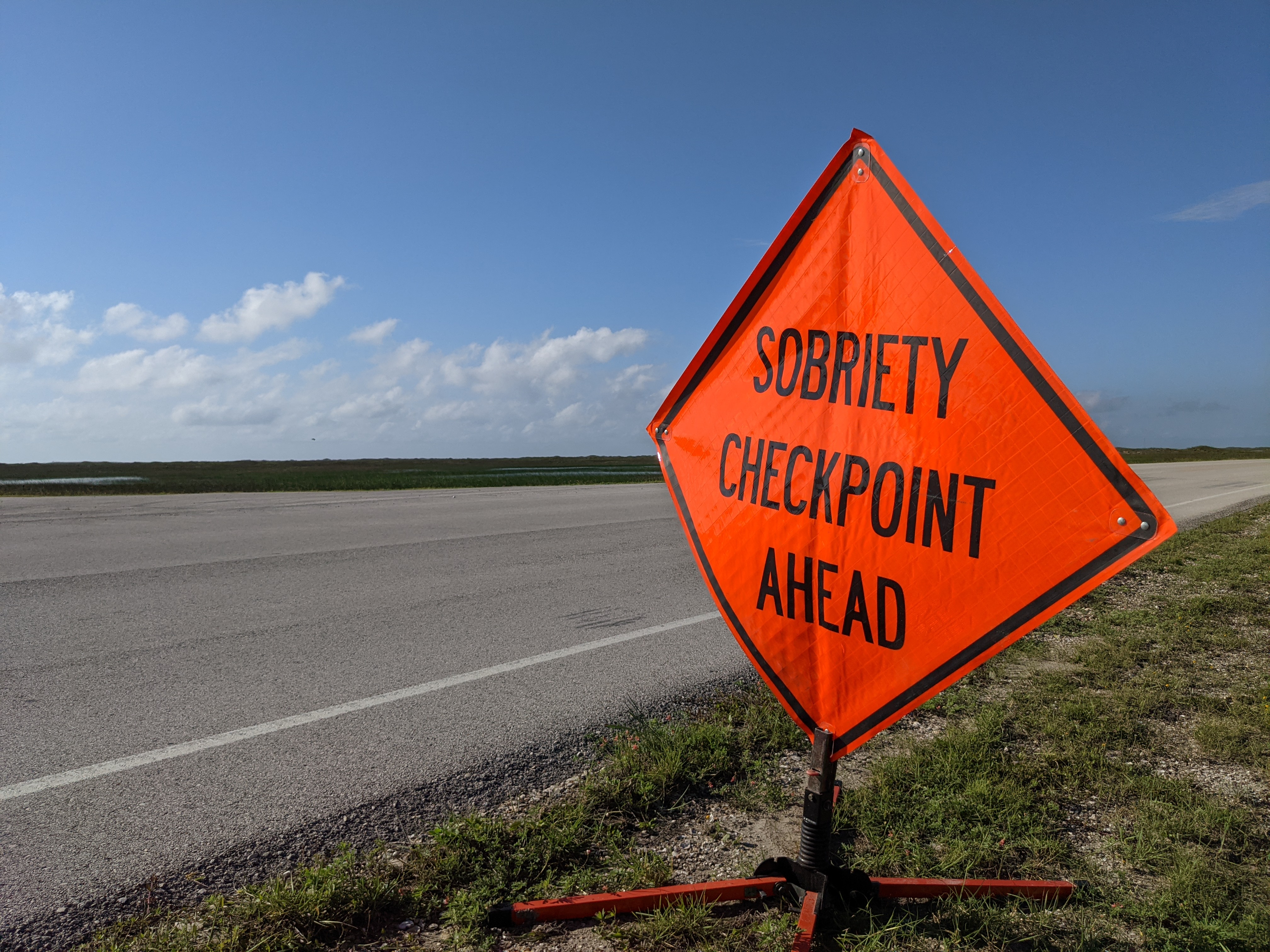 Sobriety CheckPoint Ahead Orange sign that reads "Sobriety Checkpoint Ahead"