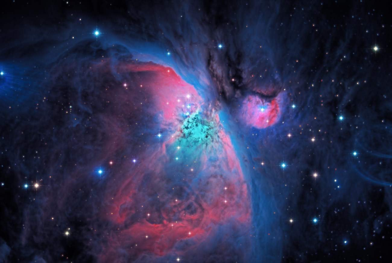It is a colorful night sky photo of the Great Nebula of Orion.