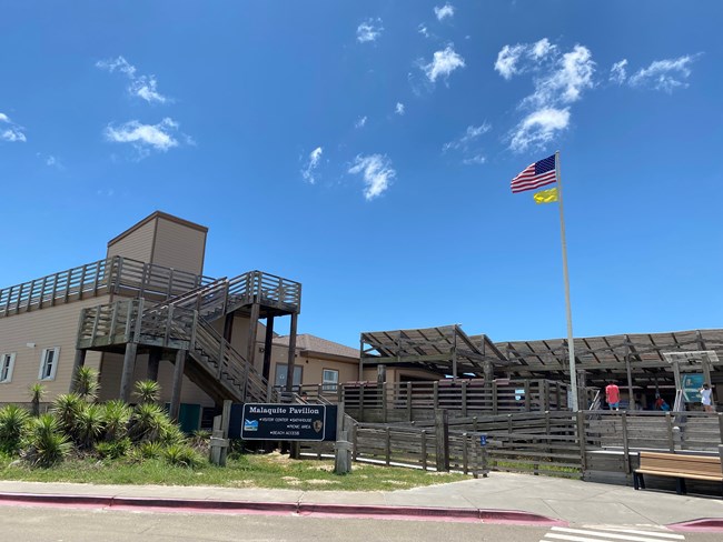 A yellow flag is displayed below the US flag at the visitor center.