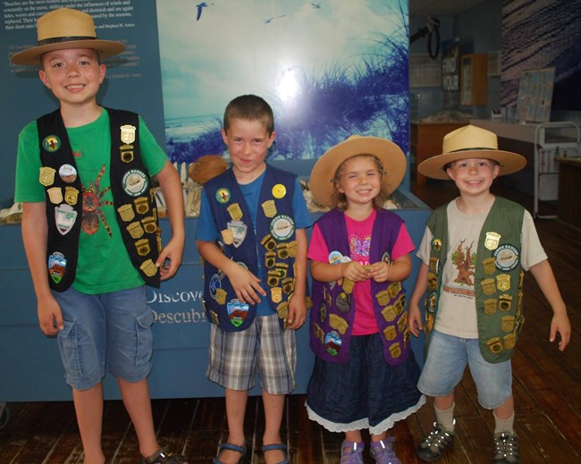 Four recently sworn-in Junior Rangers smile for the camera at Malaquite Visitor Center Four recently sworn-in Junior Rangers smile for the camera at Malaquite Visitor Center